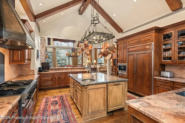 a kitchen with stainless steel appliances granite countertop a sink and stove