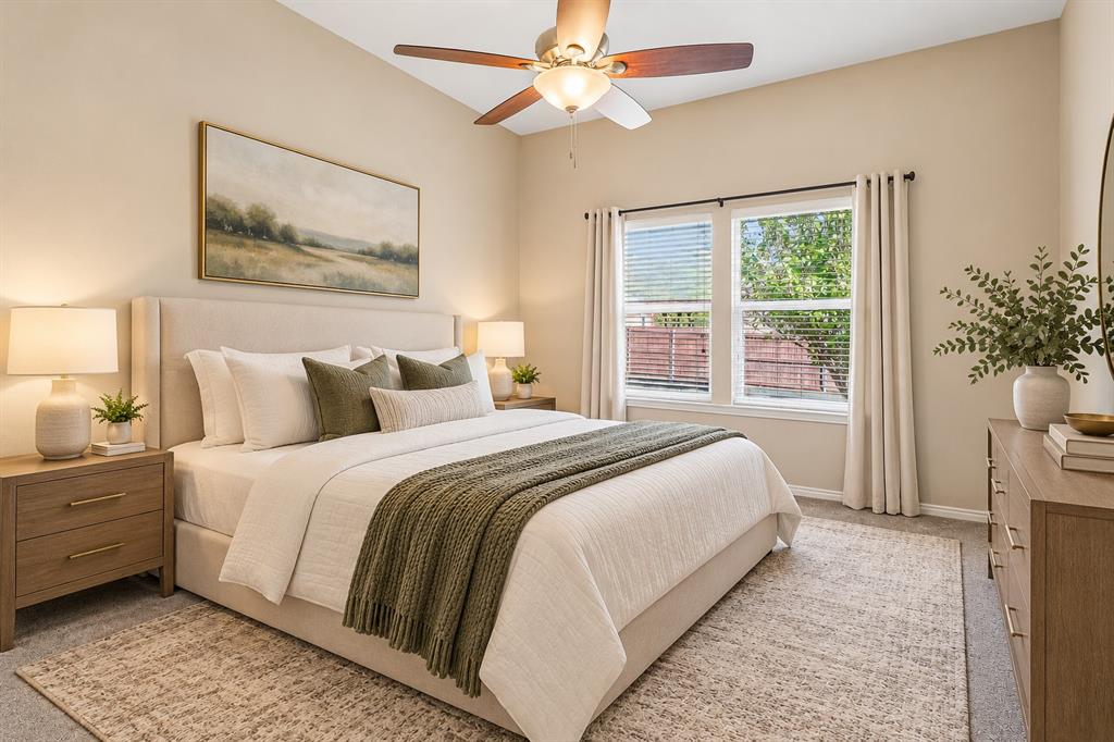 101 Ravinia Court Oak Point, TX 75068 - Photo 10 of 23 Vaulted ceiling, ceiling fan with light fixture, large windows with blinds, light-colored walls, and carpeting
