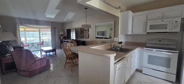 a kitchen with a stove a sink and a refrigerator