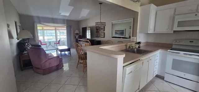 a kitchen with a sink appliances and cabinets