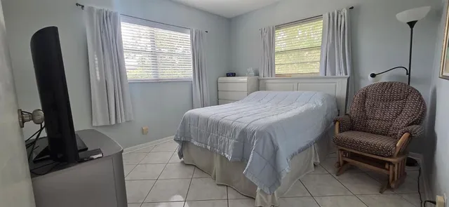 a bedroom with a bed and a chair