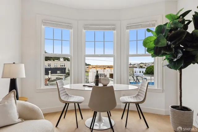 a living room with furniture a chandelier and a window