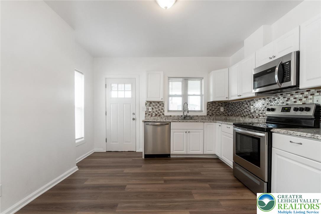 909 South Hall Street Allentown, PA 18103 - Photo 12 of 36 a kitchen with stainless steel appliances granite countertop a stove a sink and a microwave
