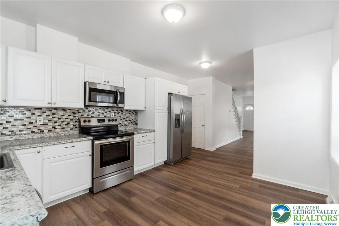 909 South Hall Street Allentown, PA 18103 - Photo 13 of 36 a kitchen with a sink a microwave and cabinets