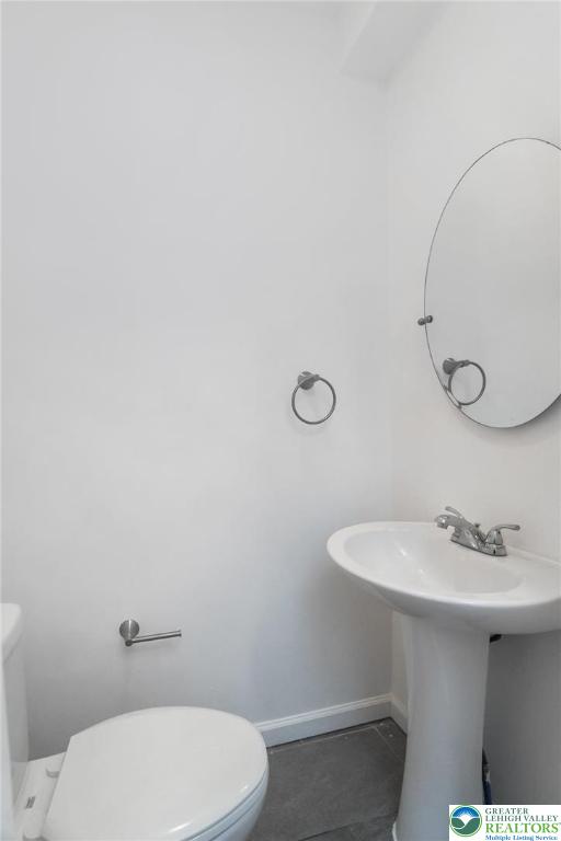 909 South Hall Street Allentown, PA 18103 - Photo 16 of 36 a bathroom with a toilet a sink and mirror