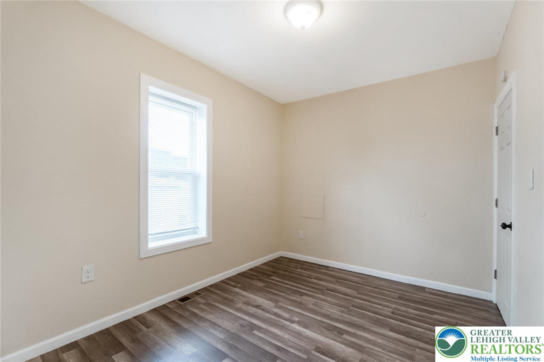 909 South Hall Street Allentown, PA 18103 - Photo 25 of 36 an empty room with wooden floor and windows
