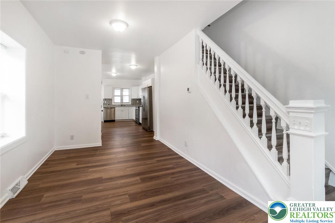 909 South Hall Street Allentown, PA 18103 - Photo 10 of 36 a view of a hallway with wooden floor and staircase