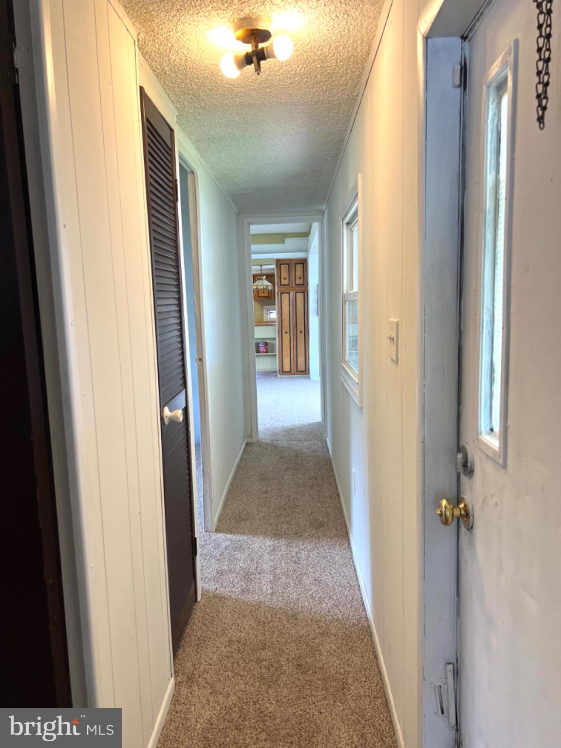 1302 Gibson Road, Unit 152 Bensalem, PA 19020 - Photo 9 of 18 a view of a hallway view with wooden floor and staircase