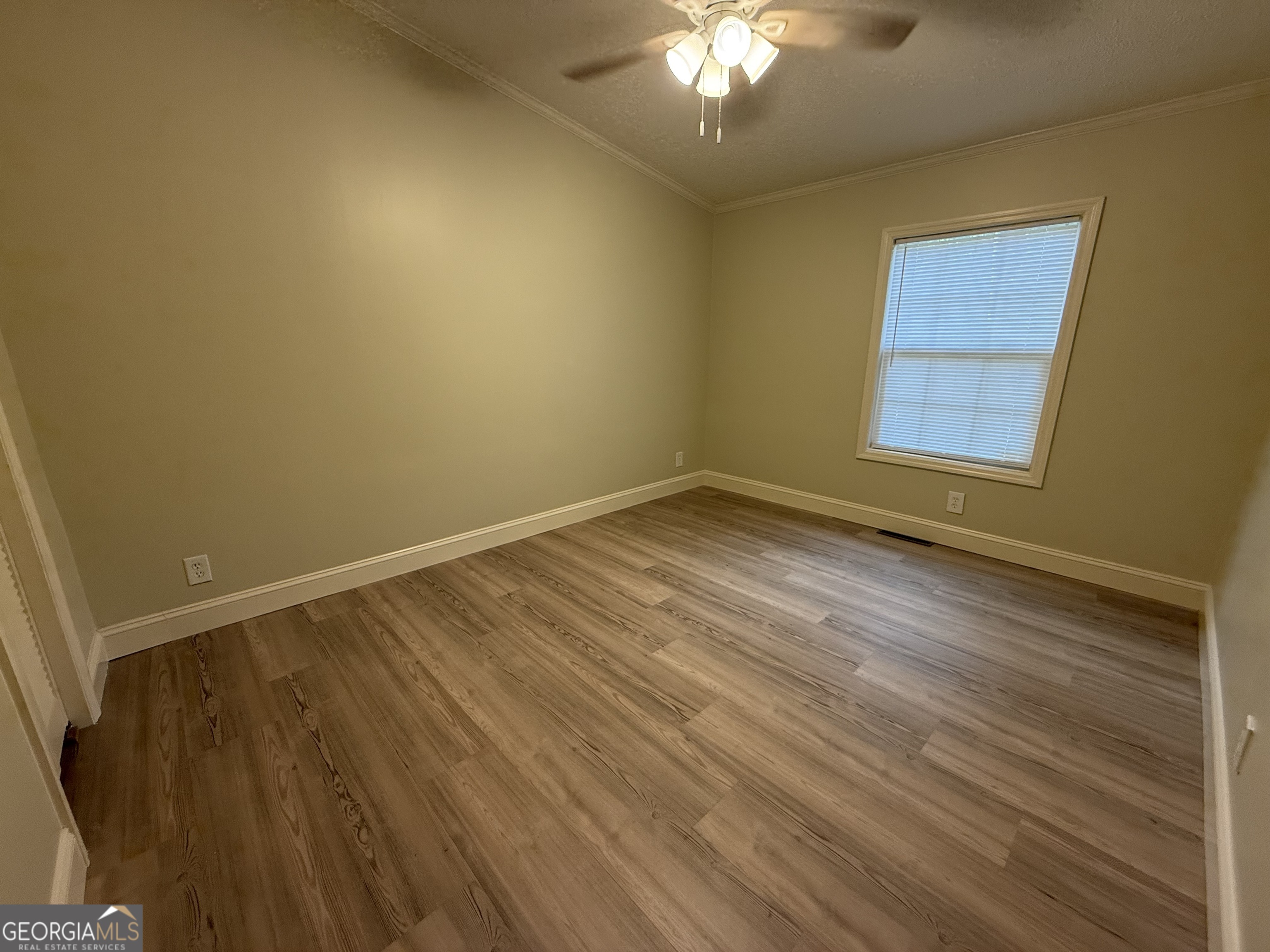 179 Creek Ridge Road Claxton, GA 30417 - Photo 11 of 19 a view of an empty room with wooden floor and a window