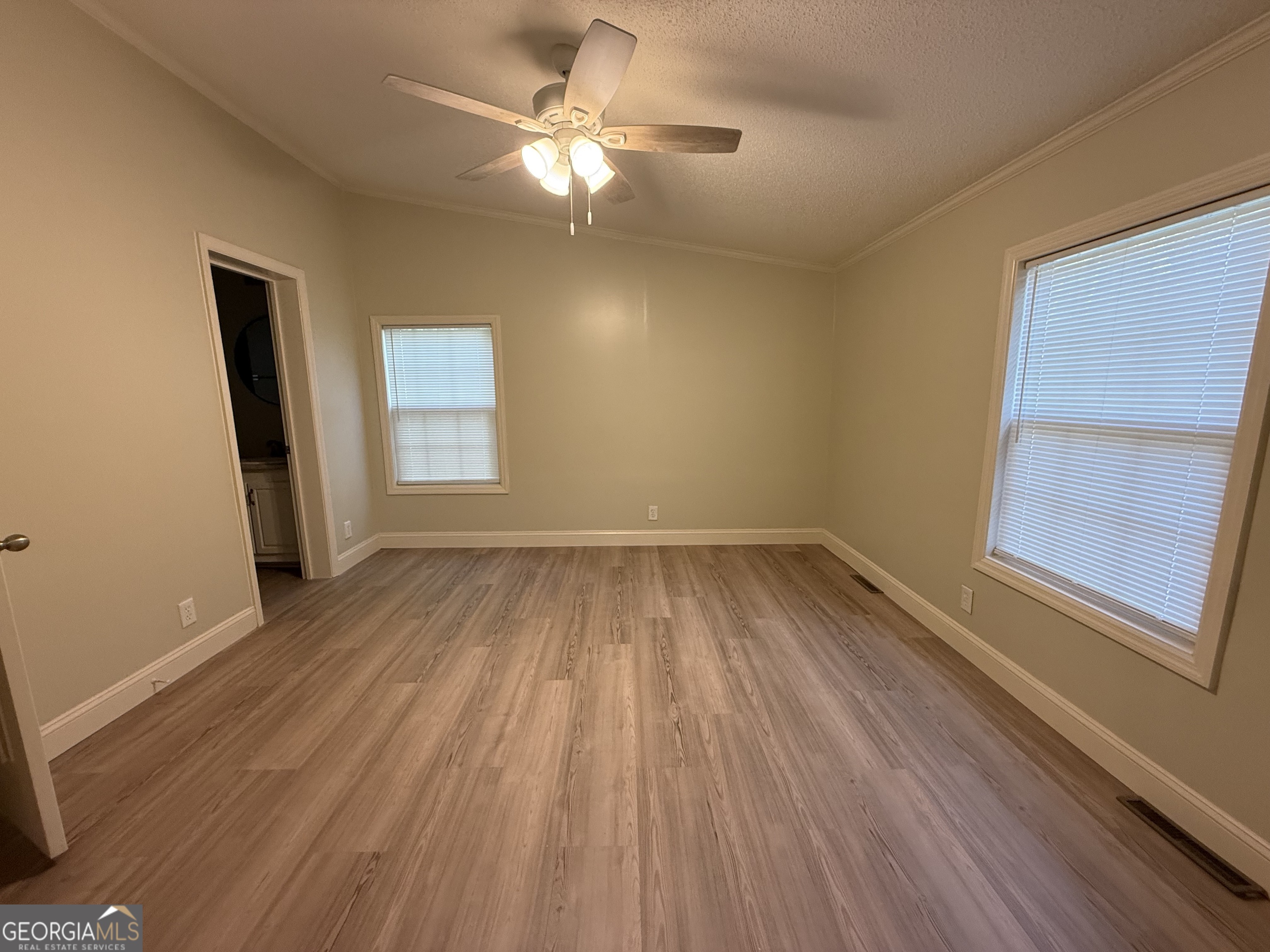 179 Creek Ridge Road Claxton, GA 30417 - Photo 13 of 19 wooden floor in an empty room with a window