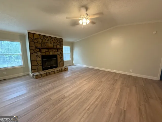 wooden floor in an empty room with a fireplace