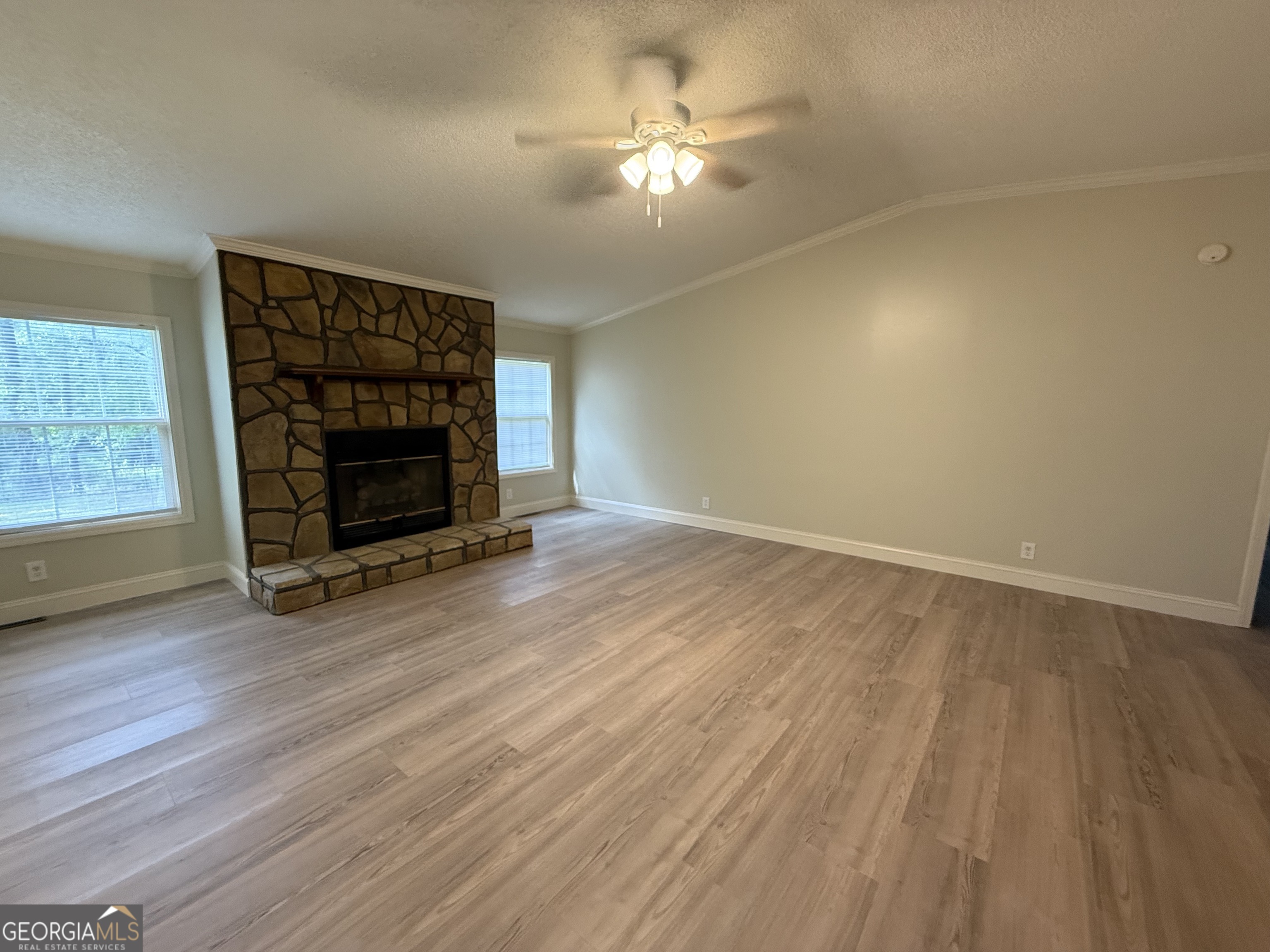 179 Creek Ridge Road Claxton, GA 30417 - Photo 5 of 19 wooden floor in an empty room with a fireplace