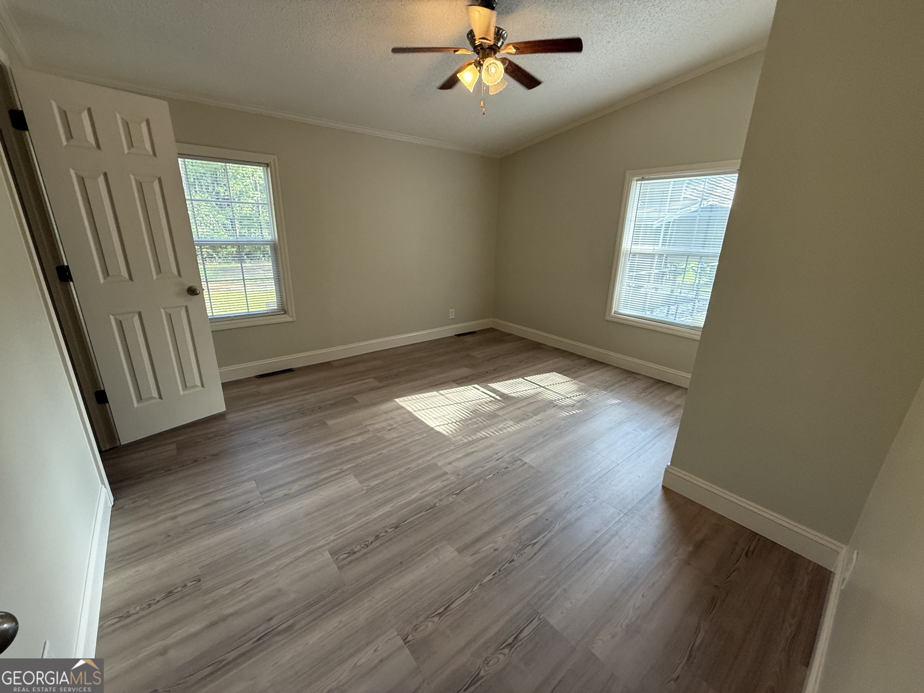 179 Creek Ridge Road Claxton, GA 30417 - Photo 10 of 19 a view of an empty room with wooden floor and a window