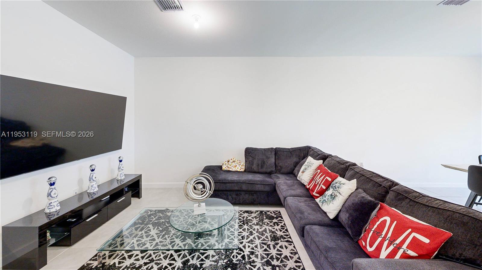 16233 Southwest 290th Terrace Homestead, FL 33033 - Photo 7 of 43 a living room with furniture and a flat screen tv