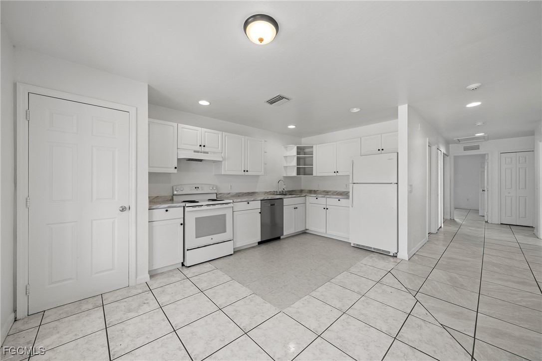 4733-4735 30th Street Southwest Lehigh Acres, FL 33973 - Photo 8 of 43 a kitchen with a white cabinets and white appliances