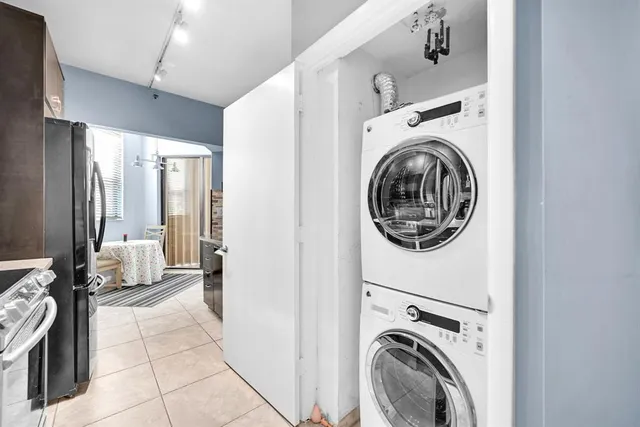 a living room with furniture a flat screen tv and a large window