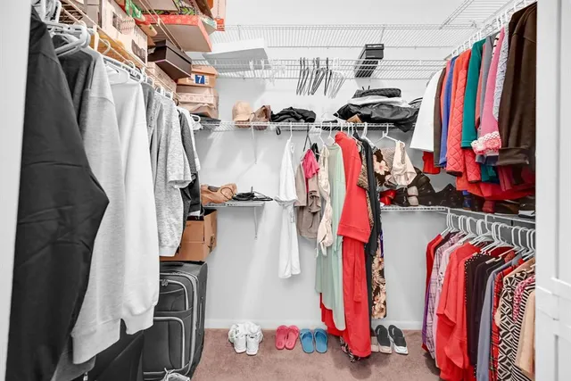 a bathroom with a granite countertop sink a mirror and a shower