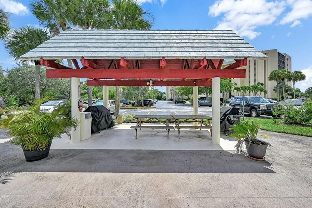 a building outdoor space with patio furniture and potted plants