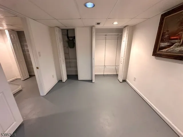 a view of hallway with stairs and wooden floor