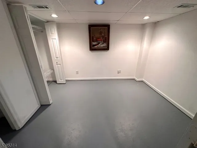 an empty room with a wooden door and a window