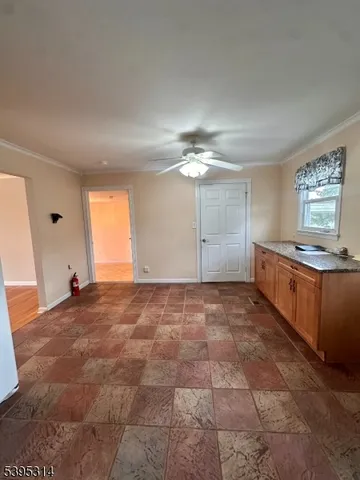a view of a kitchen with a sink and cabinets