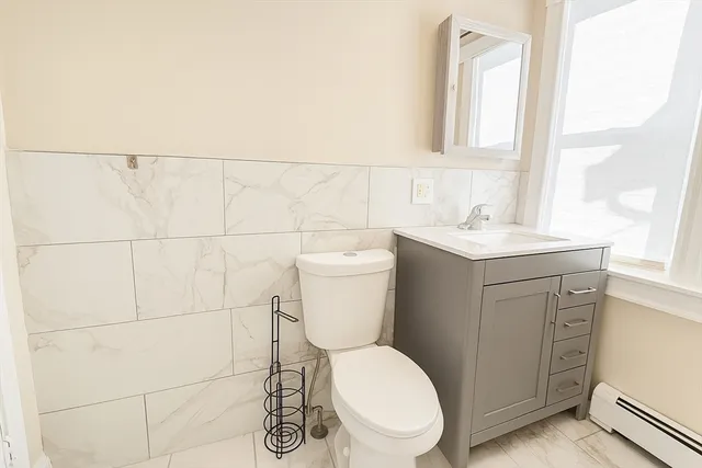 a white toilet sitting next to a bathroom sink