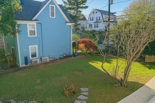 a view of a house with a backyard
