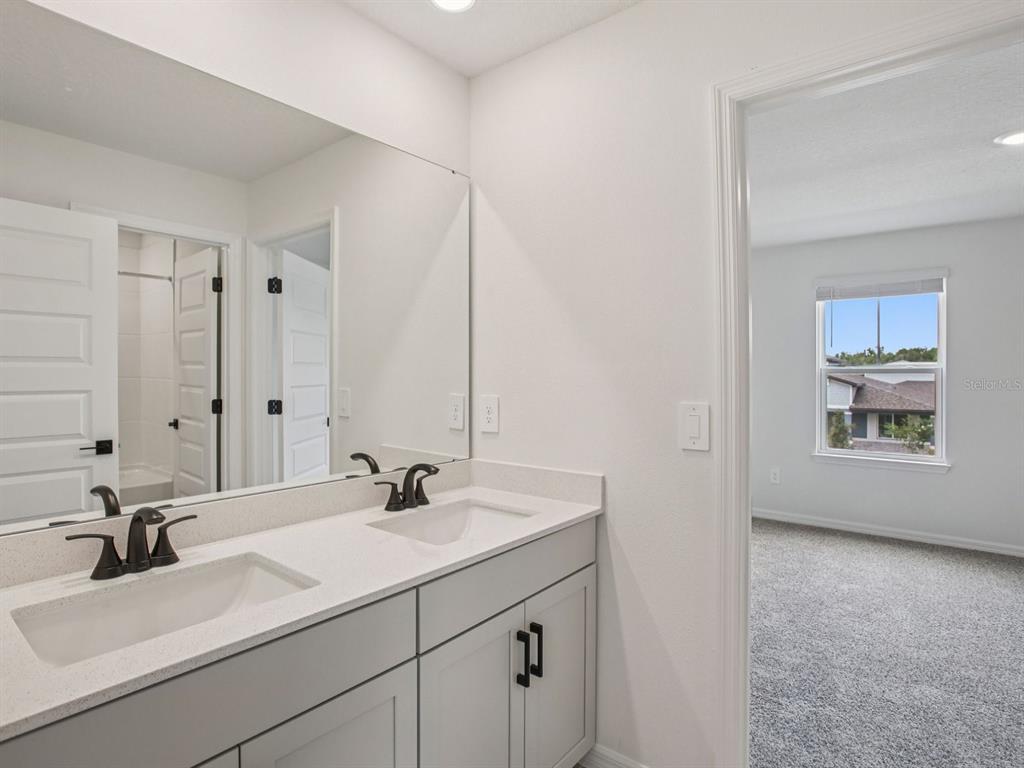 10821 Heirloom Farms Run Parrish, FL 34221 - Photo 13 of 13 a bathroom with a sink and a mirror