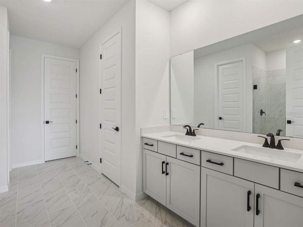 10821 Heirloom Farms Run Parrish, FL 34221 - Photo 8 of 13 a bathroom with 2 sink and a mirror