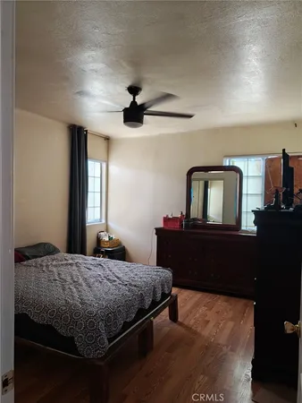 a bedroom with a bed and dresser with mirror