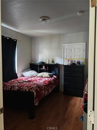 a bedroom with a bed and dresser