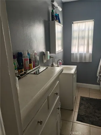 a room with a window a sink and a mirror