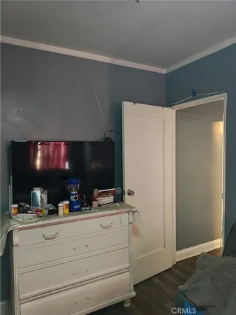 a bedroom with a bed and flat screen tv
