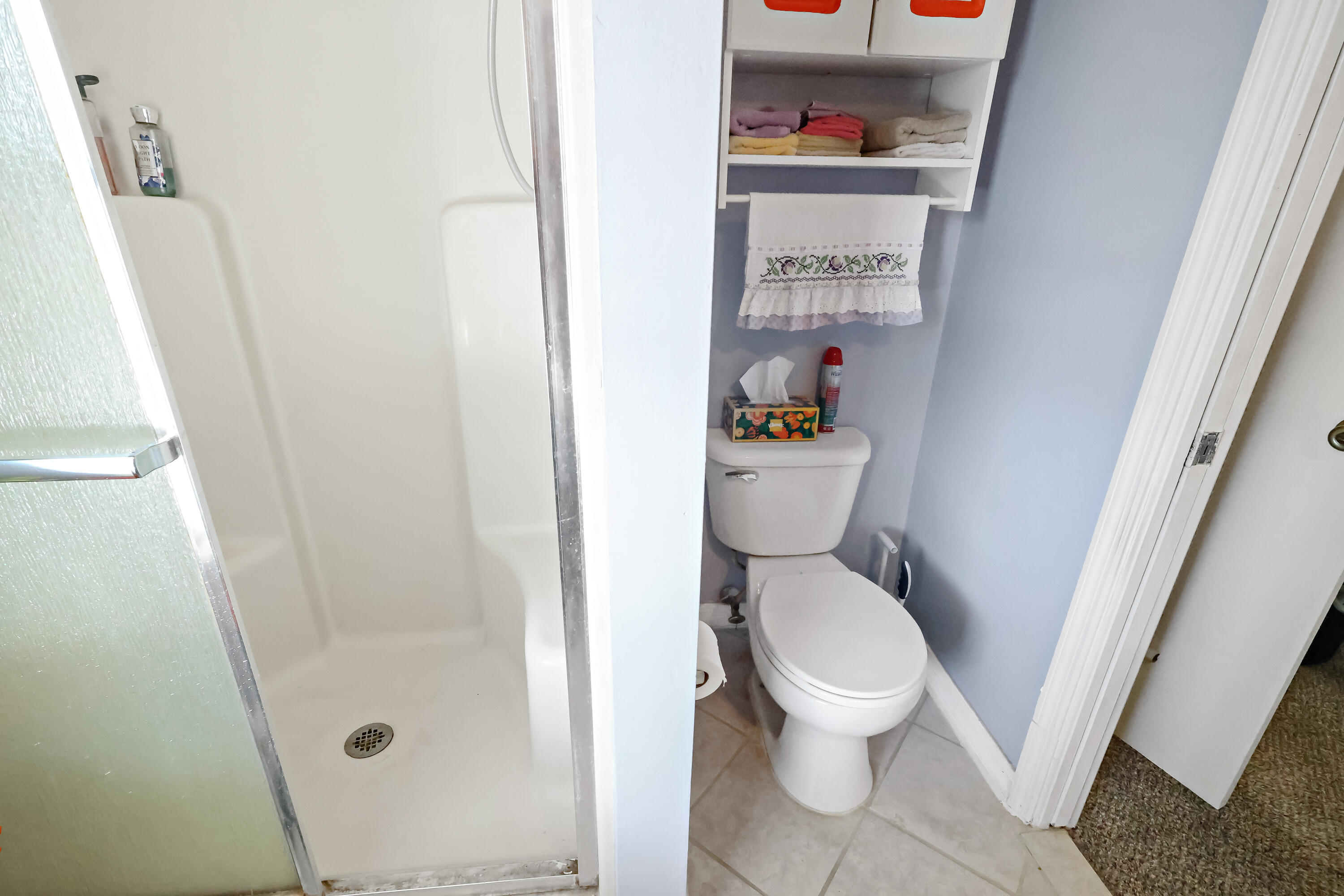 1466 24th Avenue Southwest Vero Beach, FL 32962 - Photo 12 of 29 a white toilet sitting next to a shower and a sink