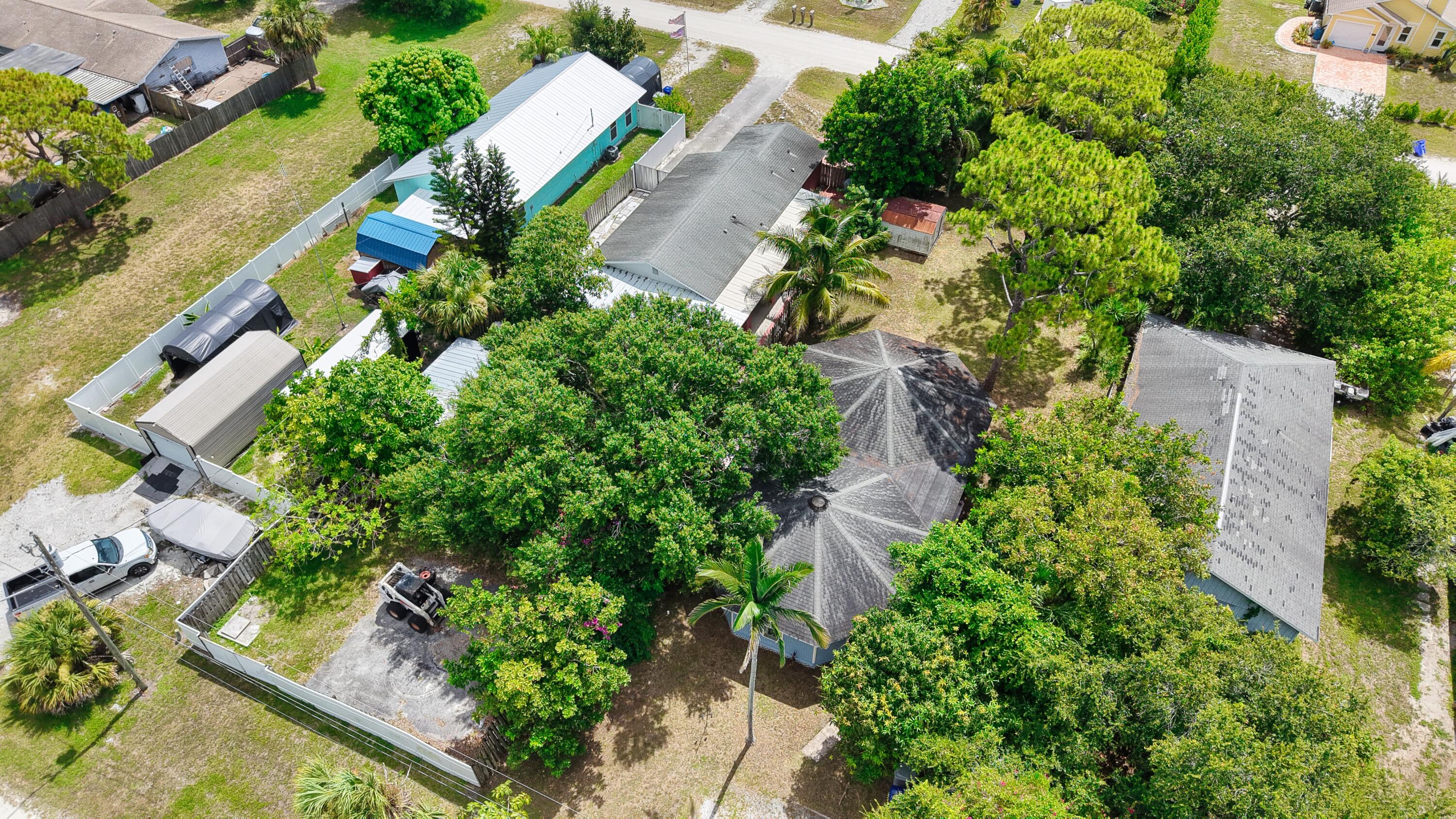1466 24th Avenue Southwest Vero Beach, FL 32962 - Photo 24 of 29 an aerial view of residential house with outdoor space and trees all around