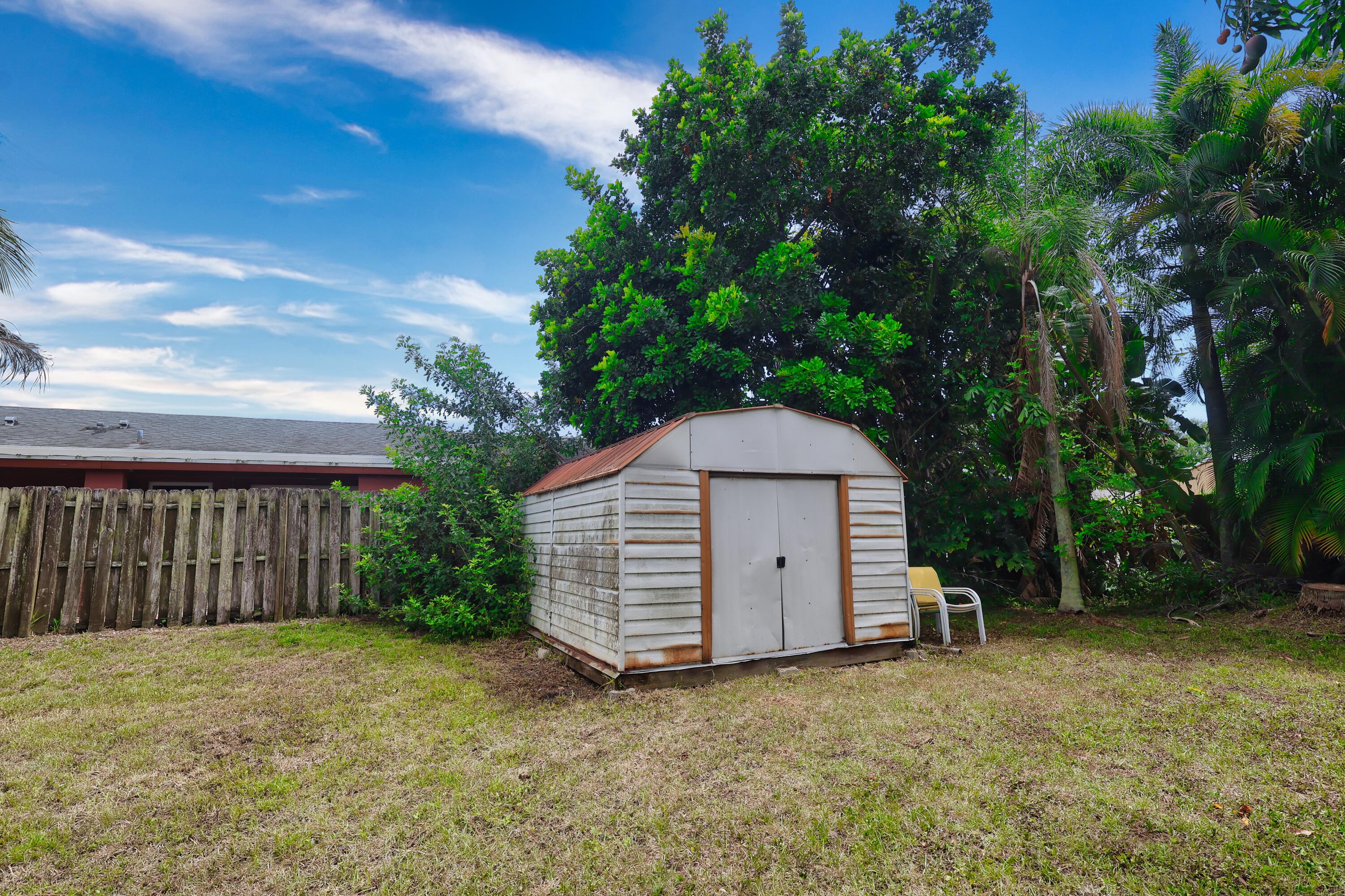 1466 24th Avenue Southwest Vero Beach, FL 32962 - Photo 25 of 29 a view of a house with a yard and large tree