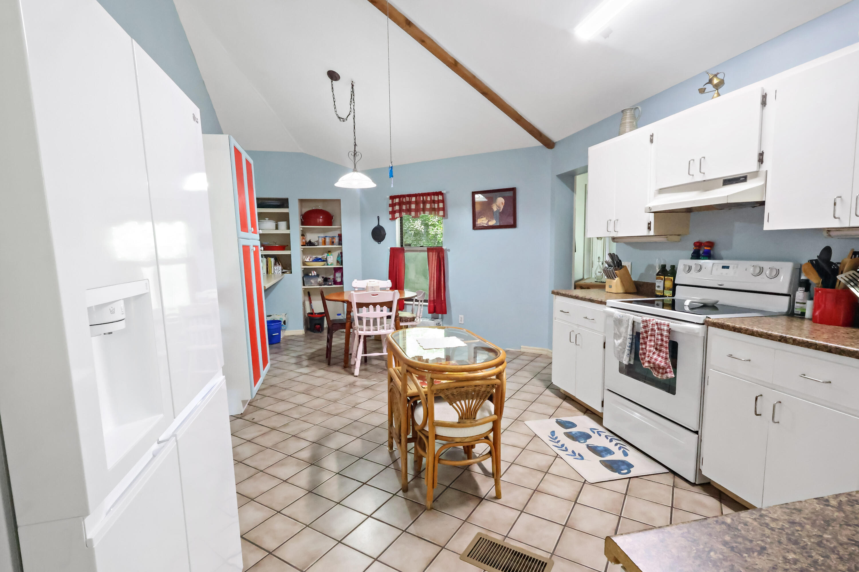 1466 24th Avenue Southwest Vero Beach, FL 32962 - Photo 4 of 29 a open kitchen with stainless steel appliances granite countertop a stove a sink dishwasher and a refrigerator with cabinets