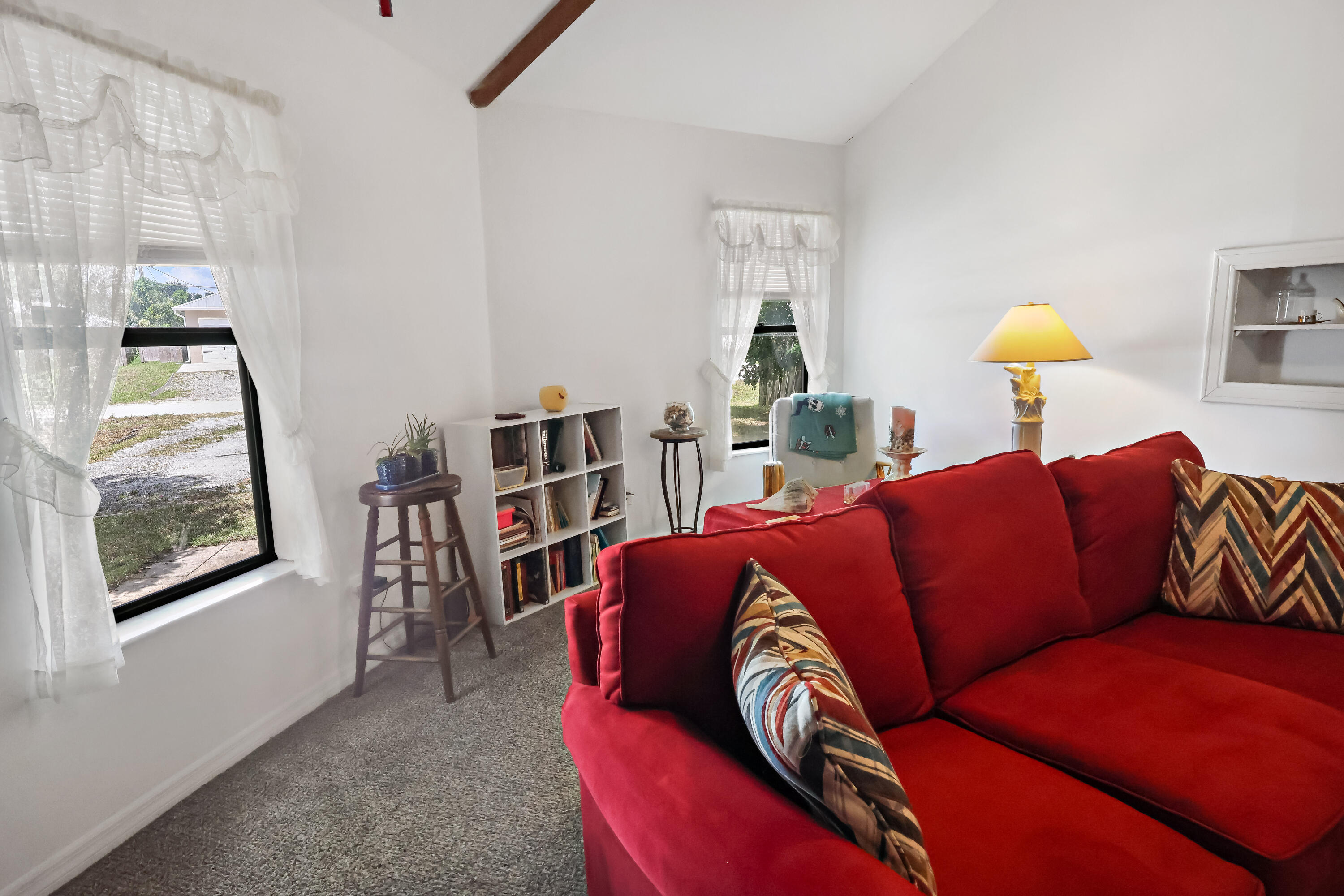 1466 24th Avenue Southwest Vero Beach, FL 32962 - Photo 7 of 29 a living room with a couch and a potted plant