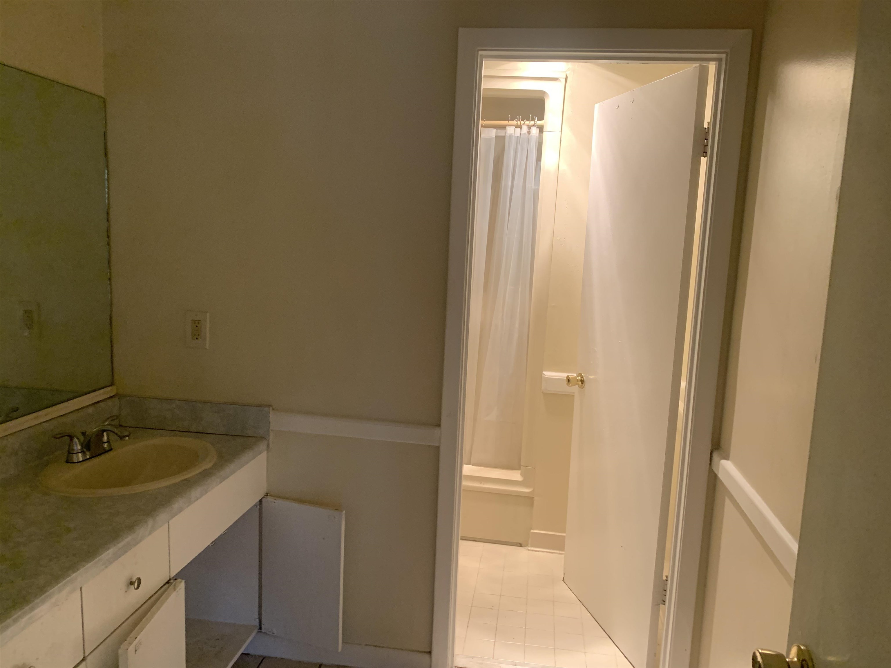 4626 St Elmo Avenue Memphis, TN 38128 - Photo 4 of 9 a bathroom with a granite countertop sink and a mirror