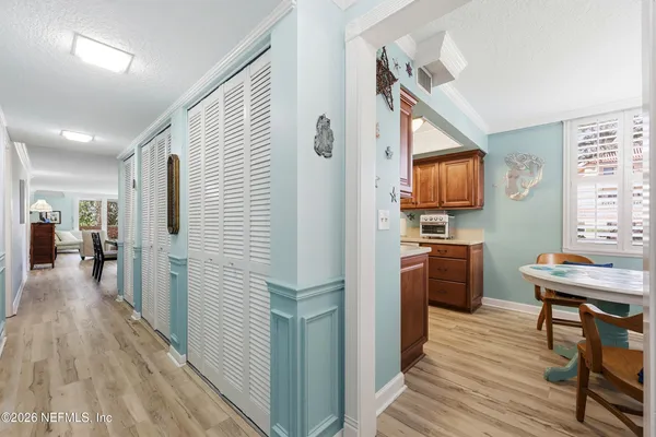 a kitchen view with furniture a counter space stainless steel appliances and cabinets