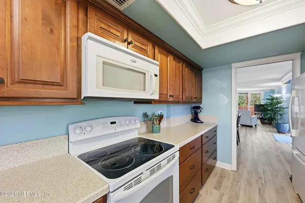 a kitchen with a stove a sink and a microwave