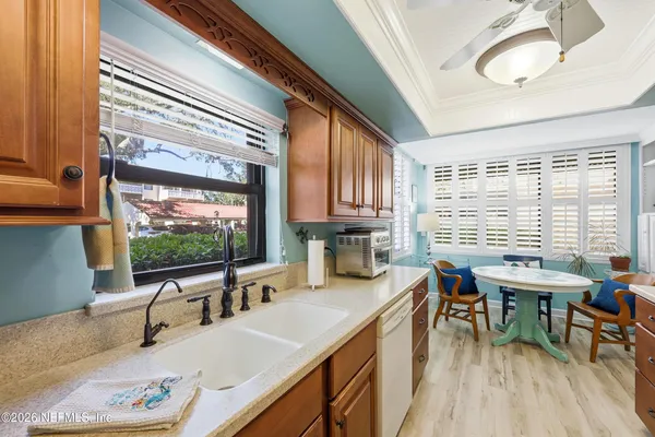 a kitchen with a large window a sink and a counter space