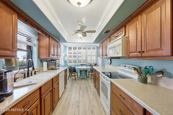 a kitchen filled counter top space a sink cabinets and a window
