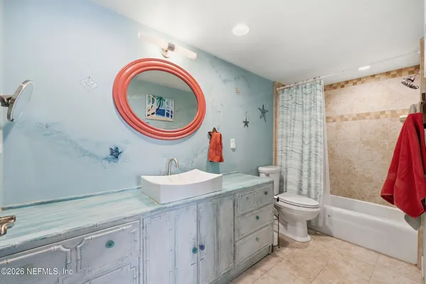 a bathroom with a toilet a sink and a mirror