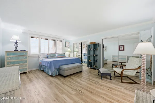 a bedroom with a bed a lamp and a dresser