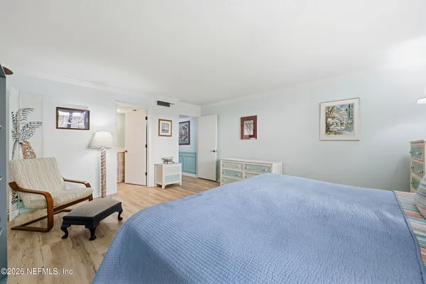a bedroom with a bed a table and chair