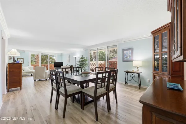 a view of a dining room with furniture and wooden floor