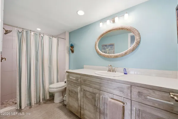 a bathroom with a toilet a sink and a mirror