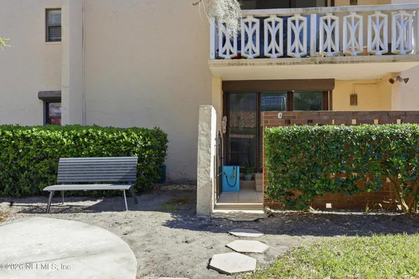 a view of an house with backyard and sitting area