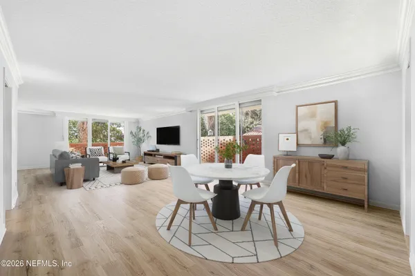 a view of a dining room with furniture and wooden floor